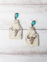 Load image into Gallery viewer, TAKE A NUMBER COWBOY WHITE COWHIDE SILVER COWSKULL STUD EARRINGS
